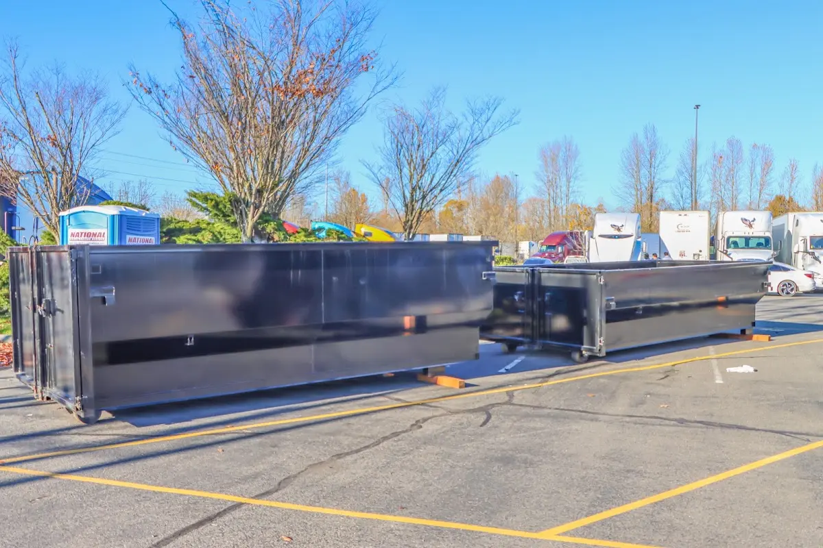 Professional dumpster rental service with roll-off container on residential driveway in Ilchester